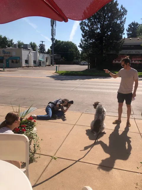 Pet photographer capturing a dog enjoying a treat outside Bonnie Brae Ice Cream, highlighting the shop's iconic Denver landmark status.