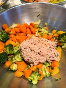 Prepared ingredients for best homemade dog food in stainless steel bowls