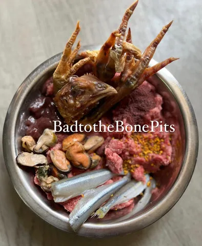 Raw ground beef meal for Pitbull with chicken heads, bee pollen, smelt, and mussels
