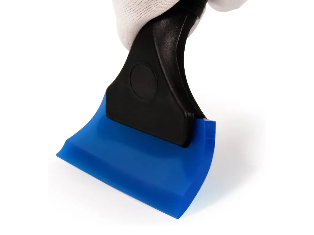 Removing pet hair from car carpet with a rubber squeegee