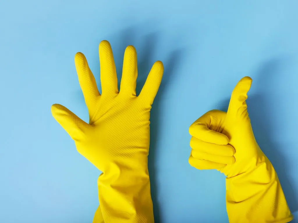 Removing pet hair from car upholstery with wet rubber gloves, a simple trick for getting dog hair out of car carpet