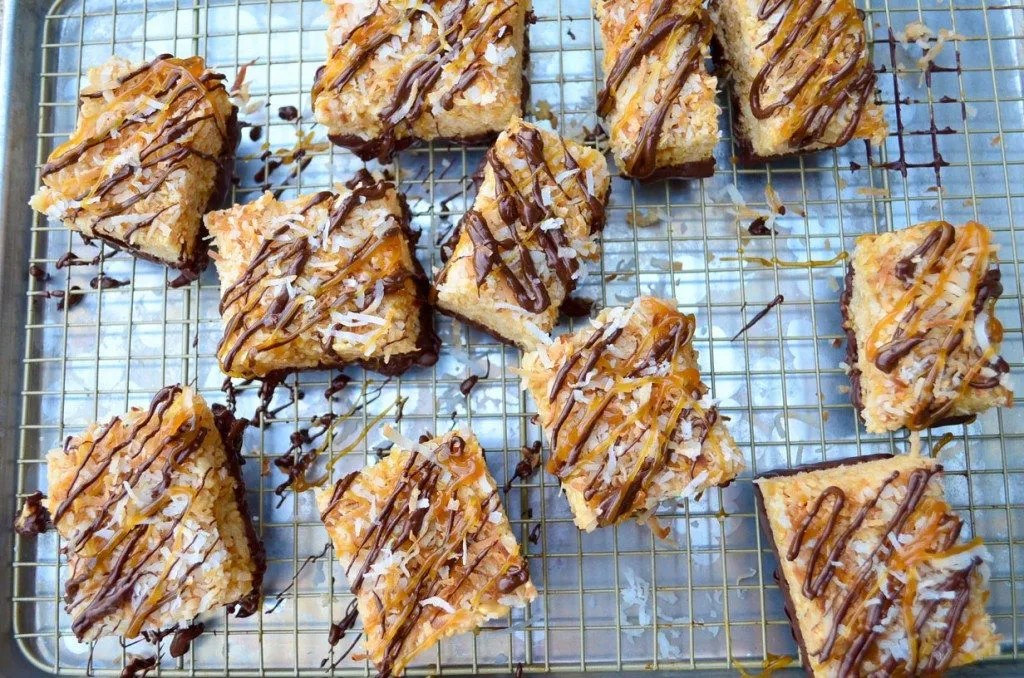 Several Samoa Rice Krispie Treats arranged on a platter, showcasing the sweet, chocolate-laced dessert that could be tempting to dogs.