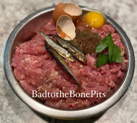 Simple raw chicken meal for Pitbull with herring, fruit, and vegetables