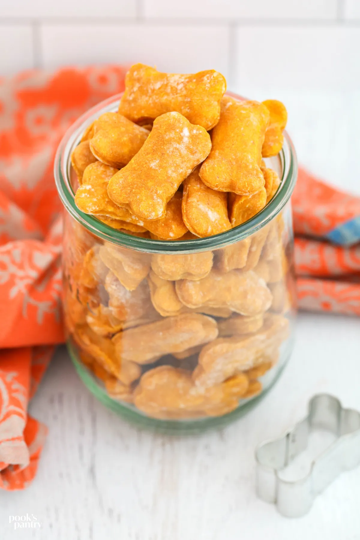 Soft, homemade pumpkin dog treats without peanut butter, stored in a glass jar for freshness.