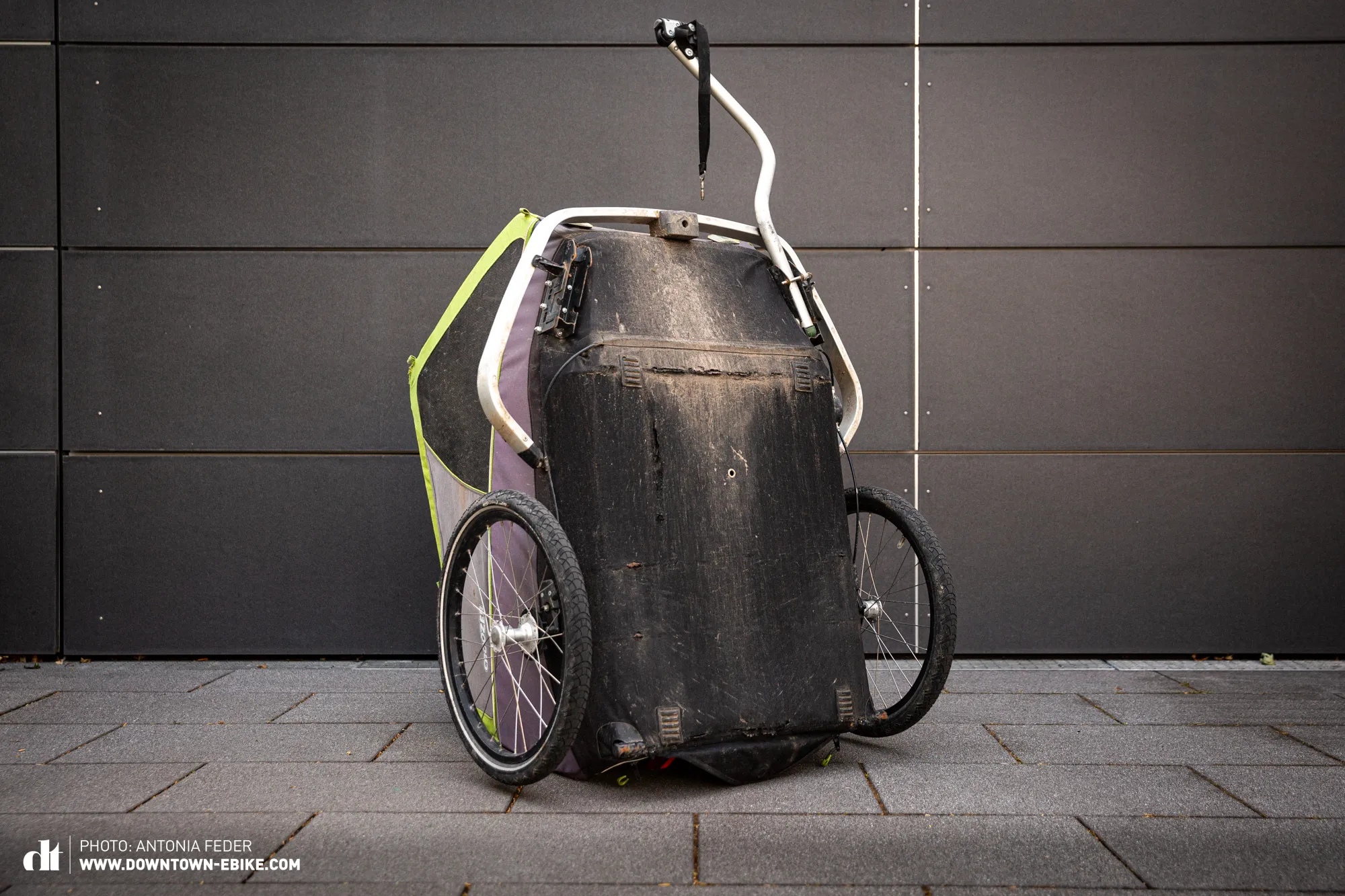 The damaged underbody of Manne's old Croozer dog trailer, illustrating wear and tear on fabric.