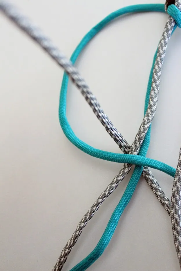 The right cord is pulled through the center of the &quot;4&quot; to complete the weave loop.