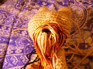 Toy Yorkie puppy with a bow in its hair