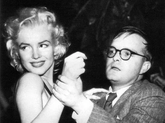 Truman Capote dancing with Marilyn Monroe, a celebrated public figure often featured in his non-fiction works like "The Dogs Bark."
