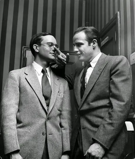 Truman Capote engaging in conversation with actor Marlon Brando, illustrating Capote's renowned interviewing prowess and ability to extract profound insights for his non-fiction writings, including essays that comprise "The Dogs Bark."