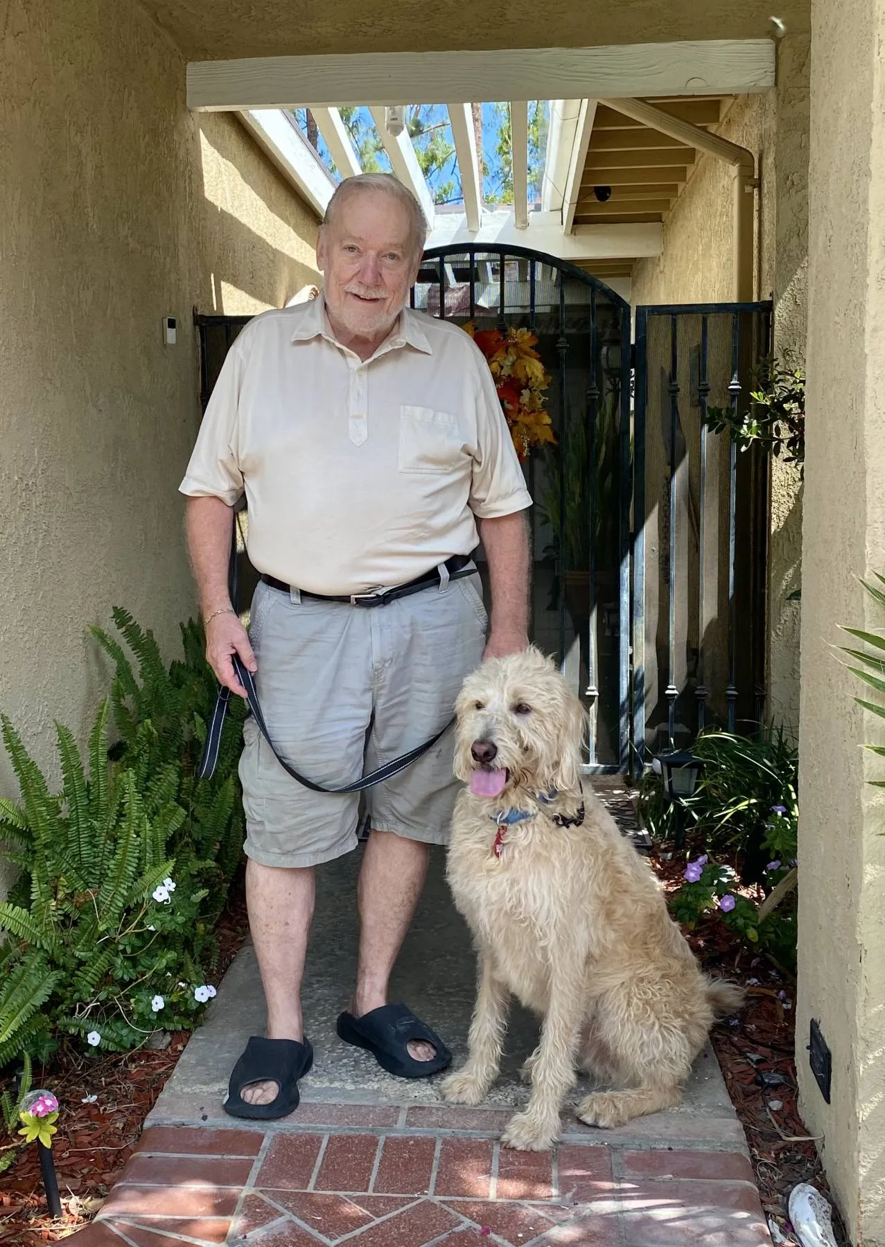 Veteran Joe and his service dog Kasey, a devoted working dog, stand together, ready for a public outing.