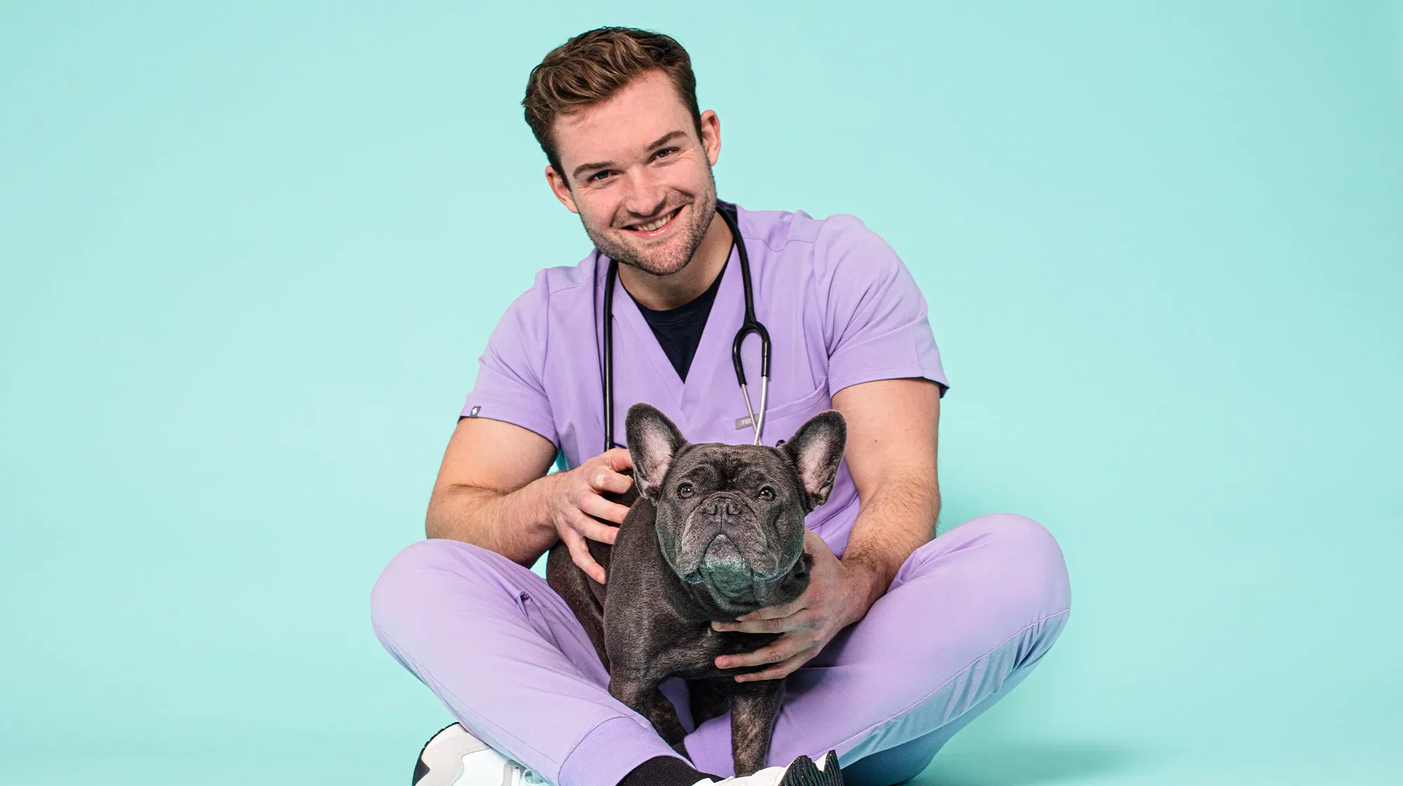Veterinarian examining a French Bulldog, discussing canine health concerns
