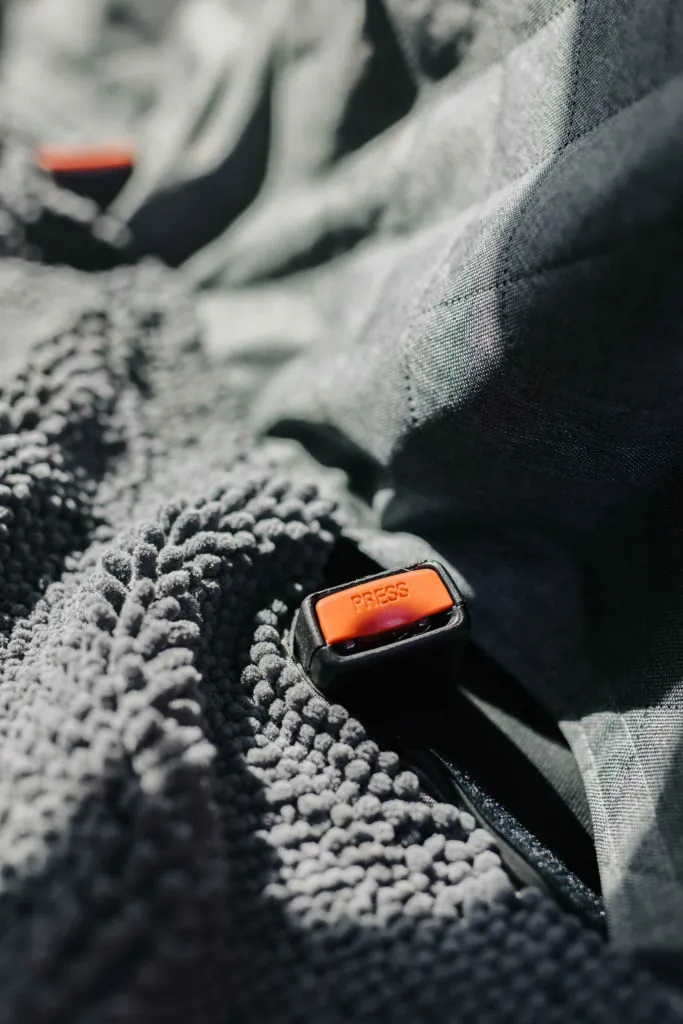 Visible seat belt openings on the DGS Pet car seat cover, allowing for easy access to car seat belts and dog harnesses.