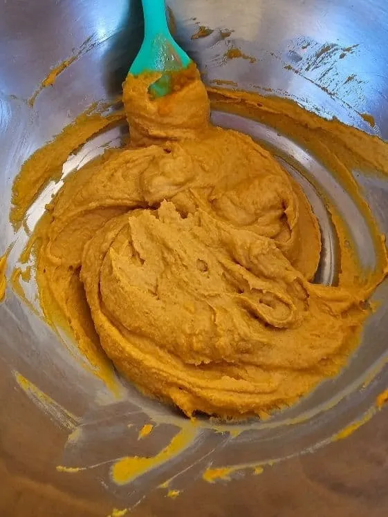 Well-combined pumpkin puree and peanut butter, forming the wet base for homemade dog treats.