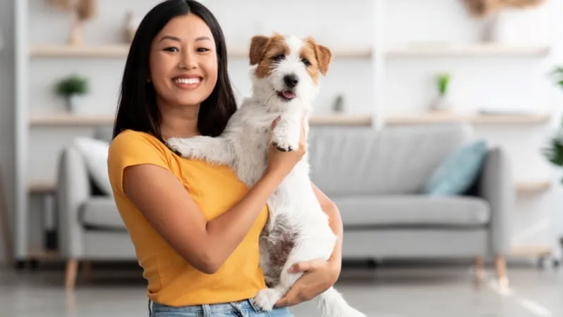 Woman gently stroking her golden retriever's head, showing a caring interaction.
