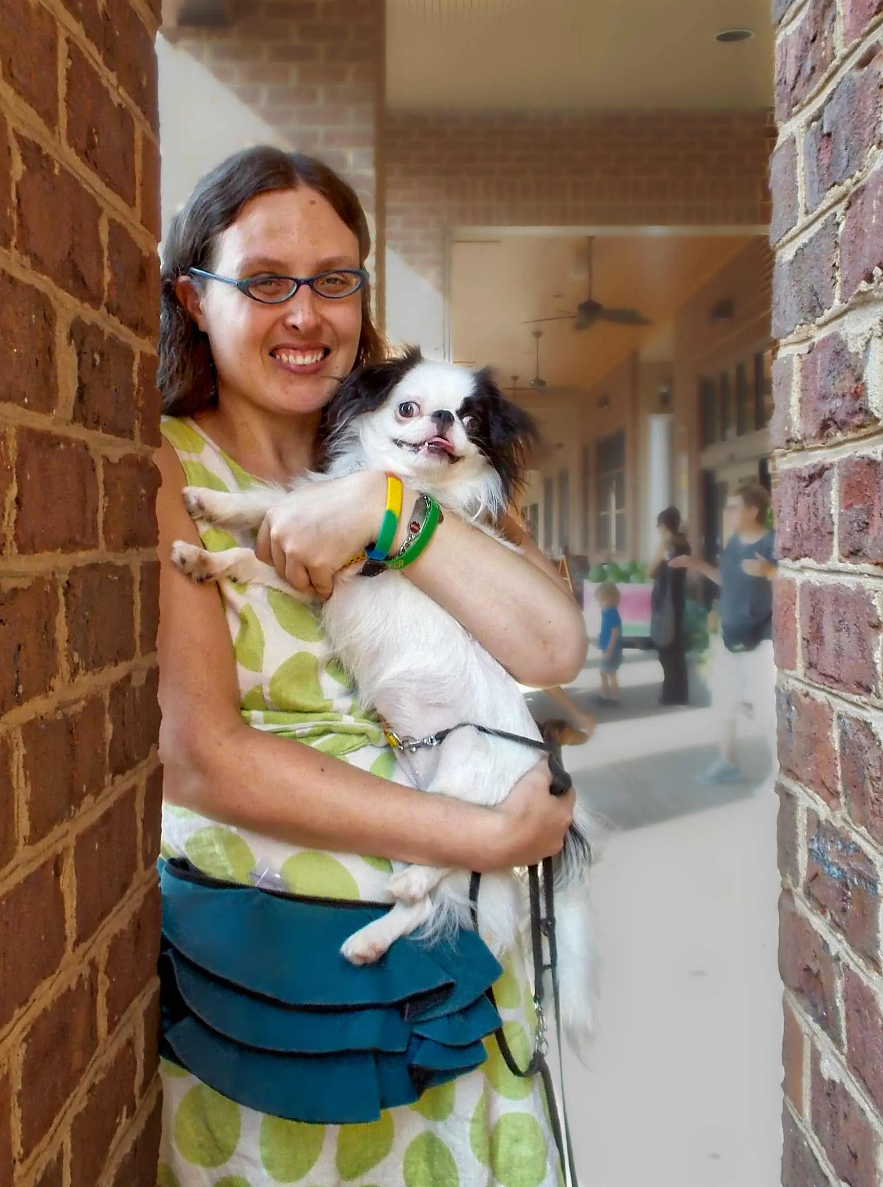 Woman holding a small puppy, representing the early stages of service dog training