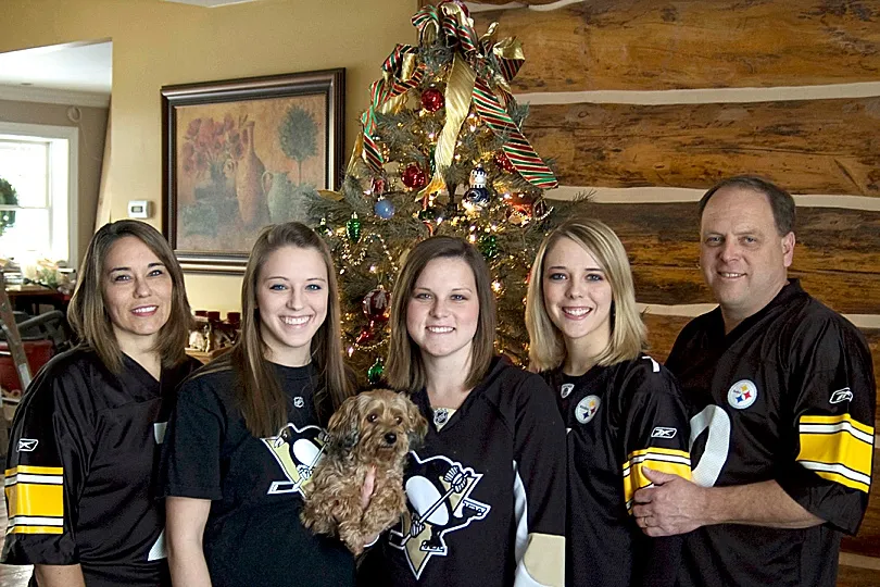 Yorkiepoo, Sophie, looking adorable and patient during a playful moment with her family.
