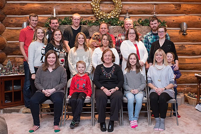 Yorkiepoo, Sophie, looking somewhat grumpy in a large family Christmas picture, standing out with her unique expression.