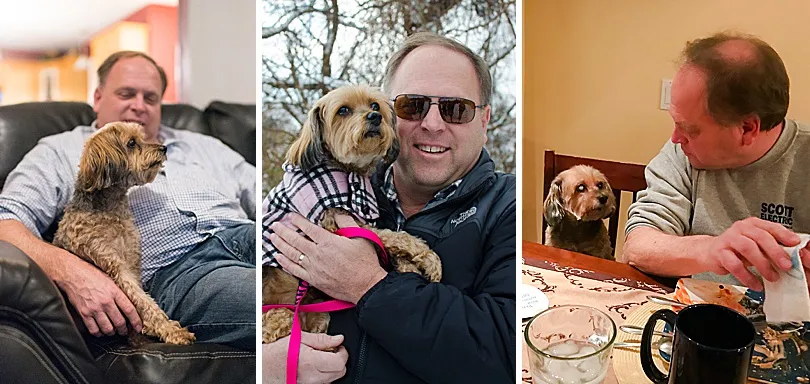Yorkiepoo, Sophie, lovingly held by her father, showcasing their undeniable and deep connection.
