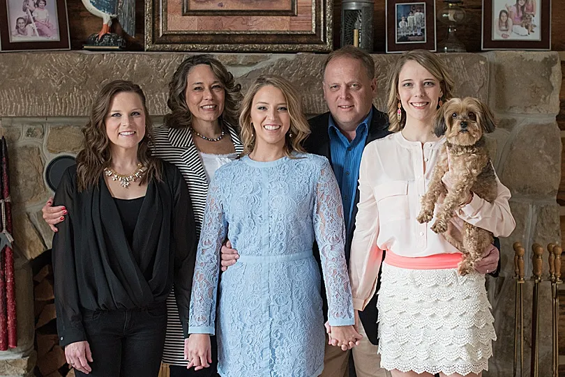 Yorkiepoo, Sophie, with the entire family, capturing a precious memory before a college graduation.