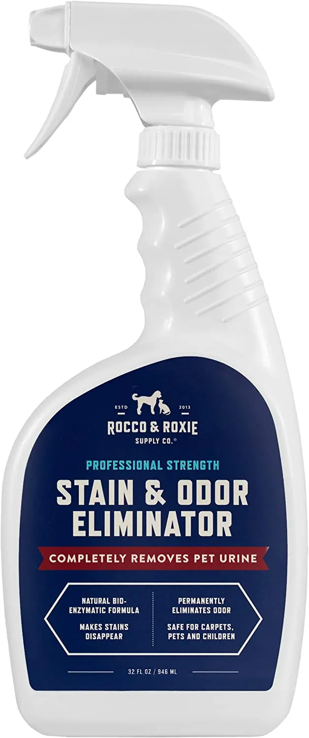 A bottle of Rocco & Roxie Stain & Odor Eliminator spray, a popular enzymatic cleaner for pet messes