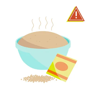 A bowl of raw dough rising on a counter