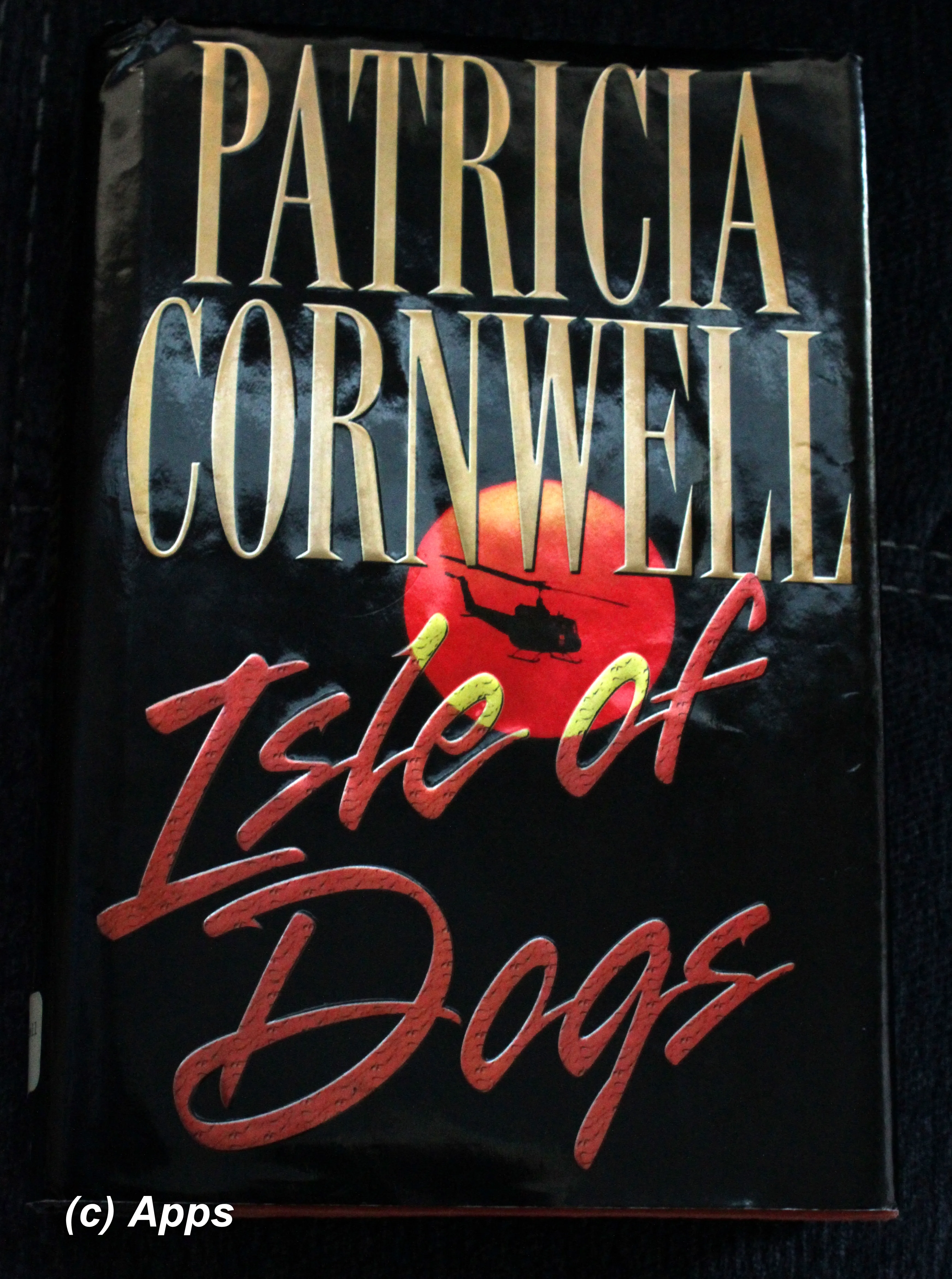 A copy of Patricia Cornwell's "Isle of Dogs" book with a dark, atmospheric cover depicting a dog-like figure