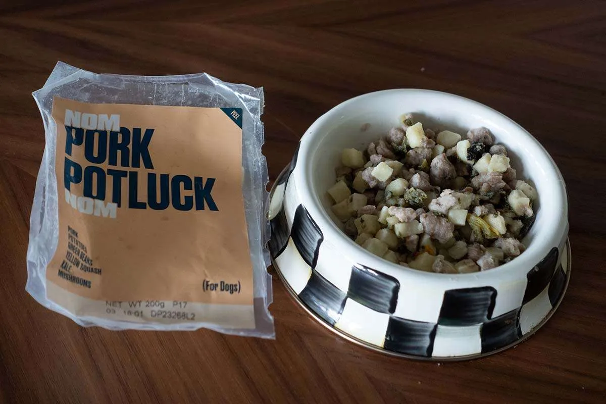 A delicious portion of Nom Nom's Pork Potluck dog food, featuring identifiable whole ingredients