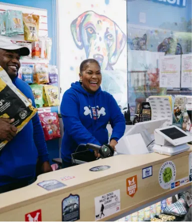 A dog posing confidently in a stylish blue jacket and a cap