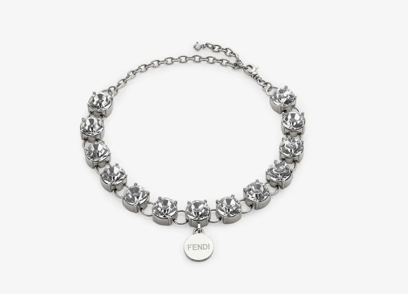 A Fendi silver-colored metal dog necklace adorned with 13 white crystals and a Fendi logo pendant