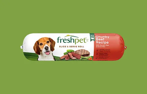 A Freshpet roll for small dogs displayed prominently with vibrant, fresh ingredients visible