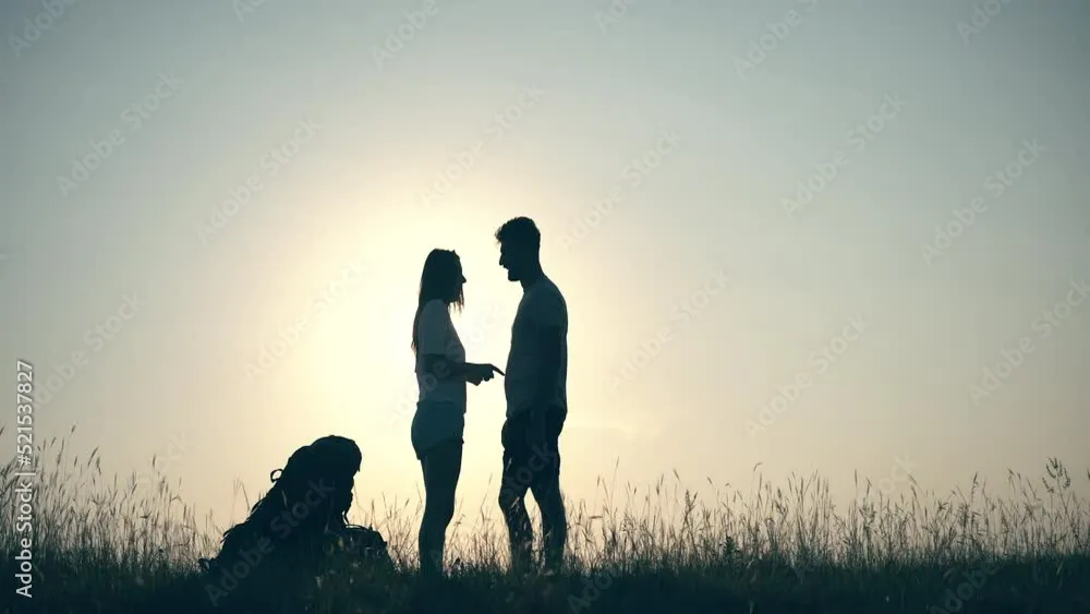 A happy dog with a shiny coat eating from a food bowl