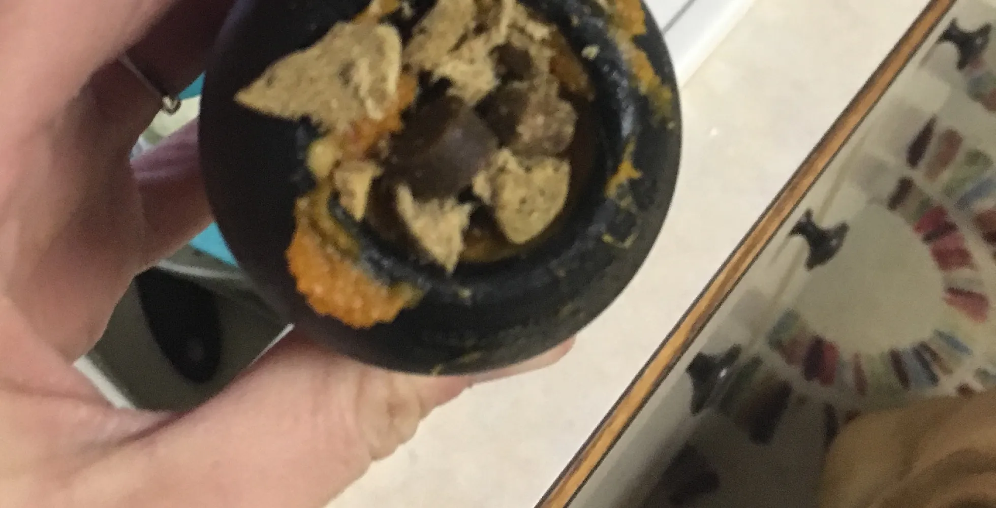 A Kong toy with added crunchy dog treats or kibble on top of soft food