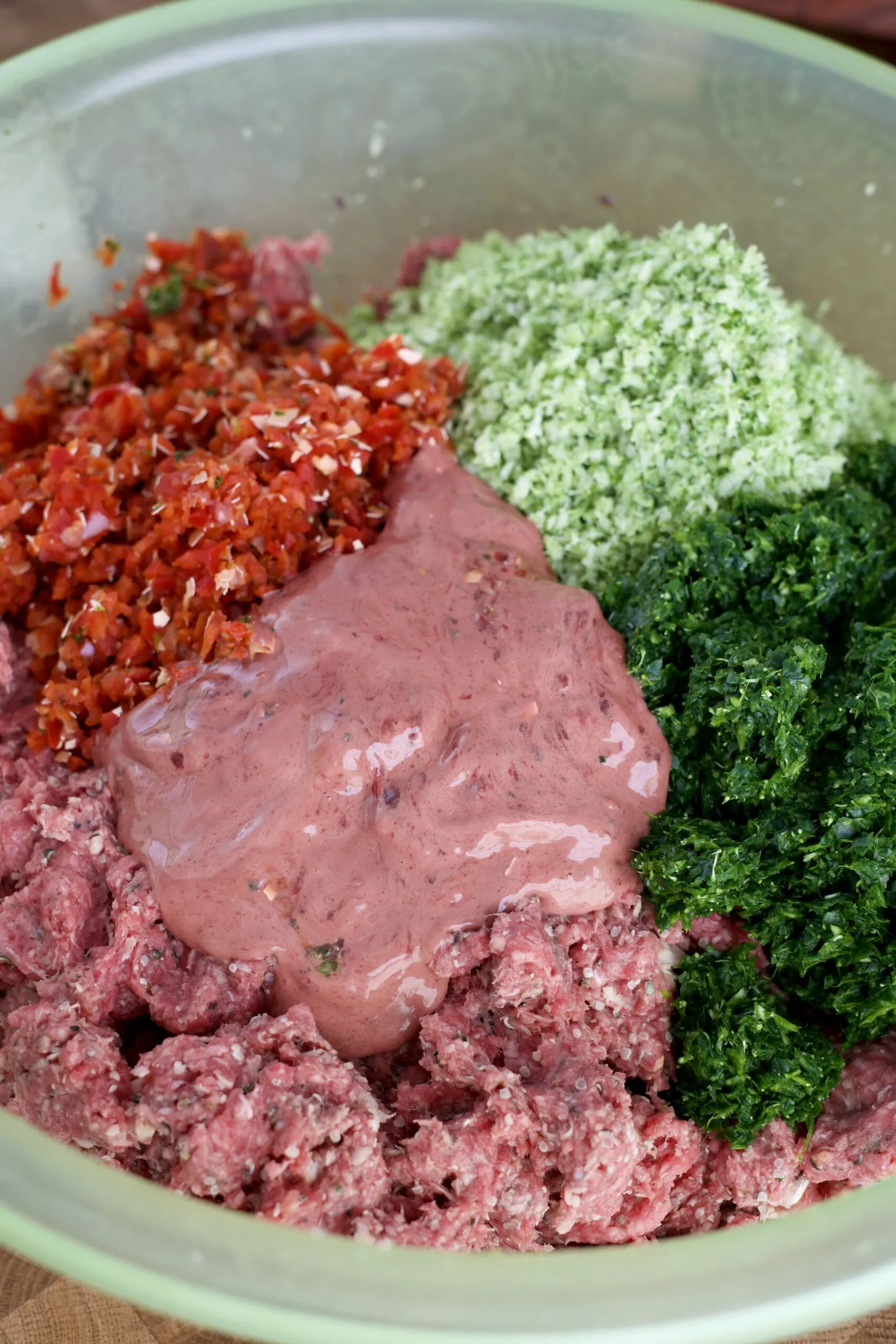 A large bowl with the final mixture of meat and blended vegetables, ready for portioning