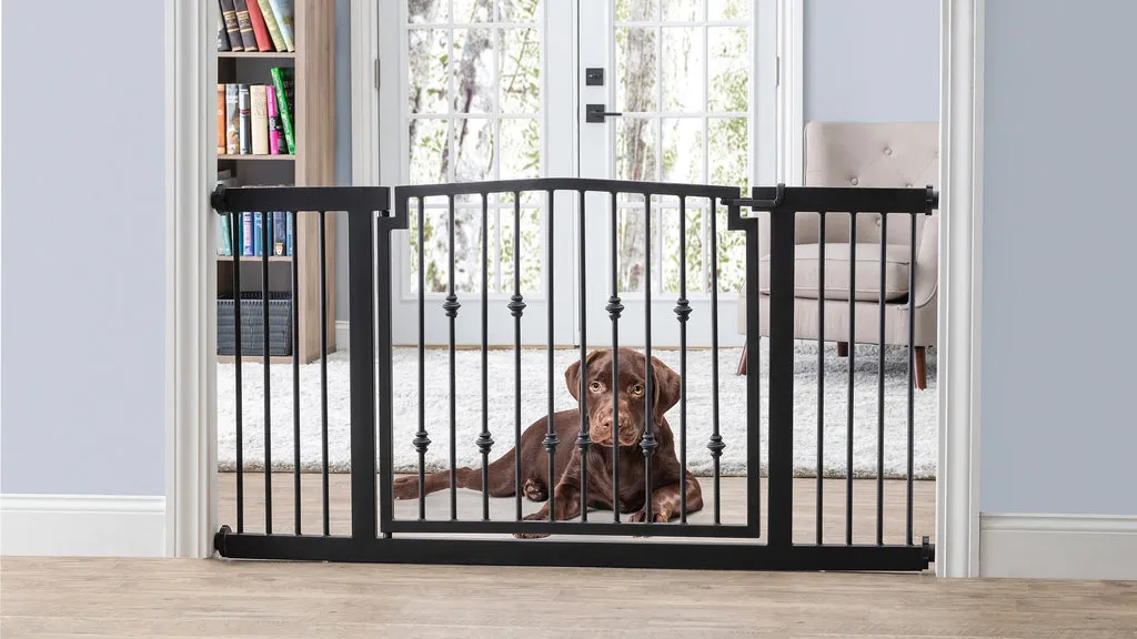 A large, sturdy pressure-mounted dog gate with a walk-through door installed in a wide doorway