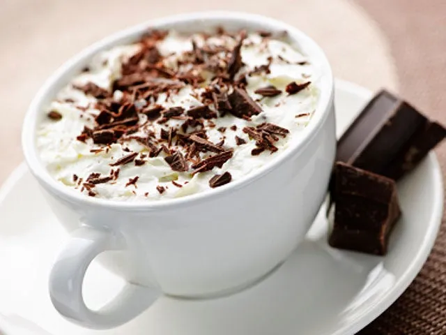 A latte, a cup of coffee, and hot chocolate, all common sources of caffeine.