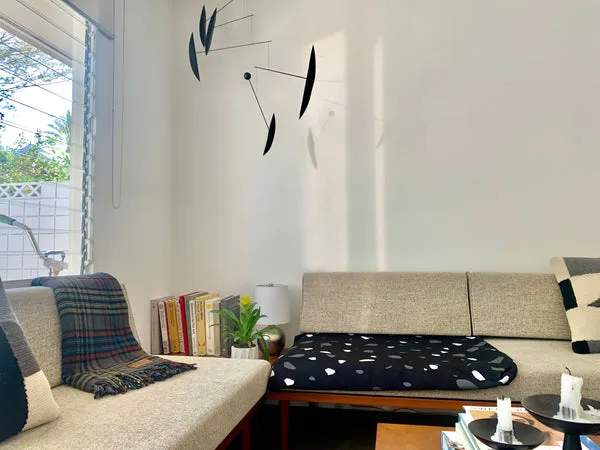 A modern dog bed cover placed on a sofa, allowing the dog to join on invitation.