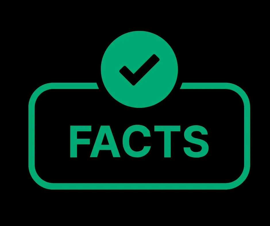 A person's hands holding a dog treat, offering it to a dog sitting calmly inside a metal crate