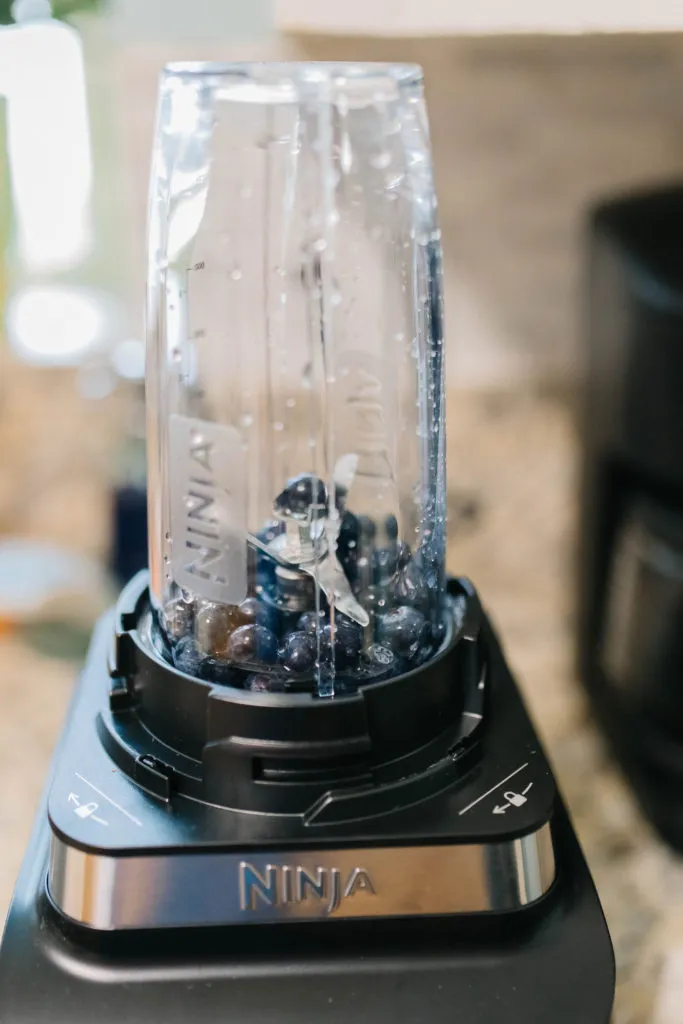 A prepared Lickimat Buddy with a vibrant blueberry smoothie