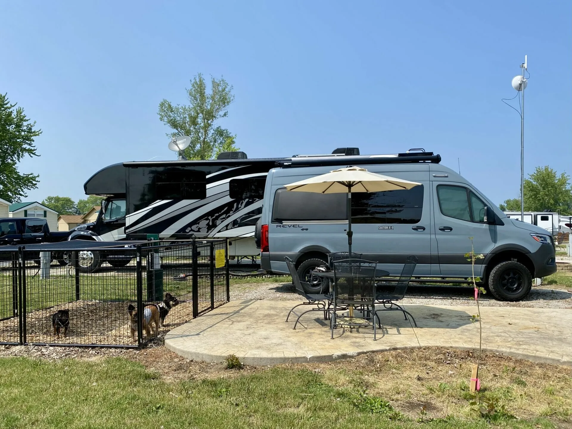 A private dog pen at Sandusky / Bayshore KOA featuring a woodchip base and overhead shade cloth