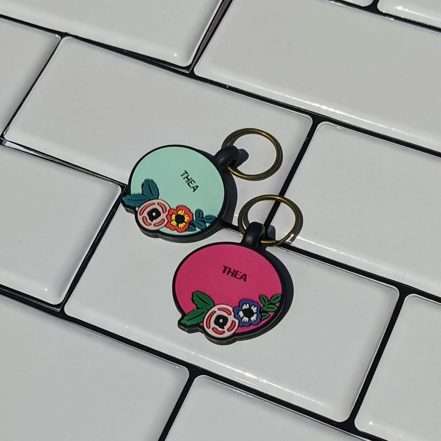 A relaxed dog lying down outdoors, showcasing its QALO silicone ID tag.