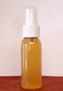 A small bottle of homemade yellow fluid, ready to be used as an anti-itch spray for dogs