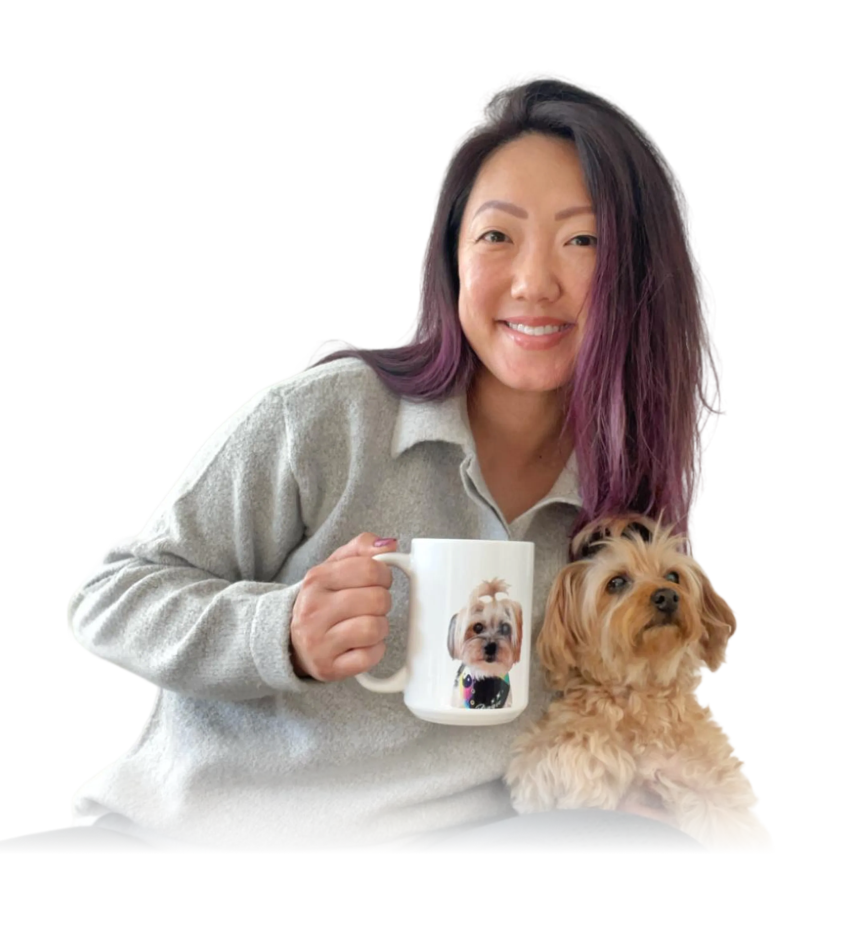 A smiling woman with dark hair and purple highlights is holding a white mug that features a portrait of a fluffy dog.
