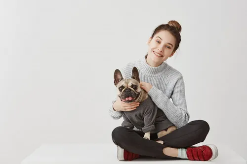 A veterinary professional interacting gently with a dog in a clinic setting, highlighting the compassionate care.