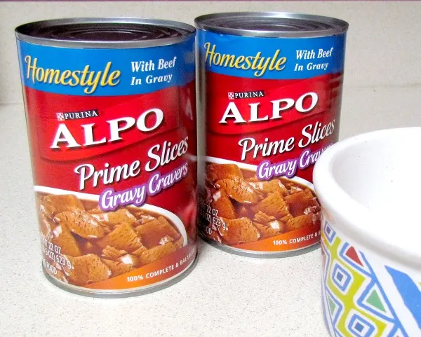 A vibrant can of ALPO wet dog food sits on a countertop