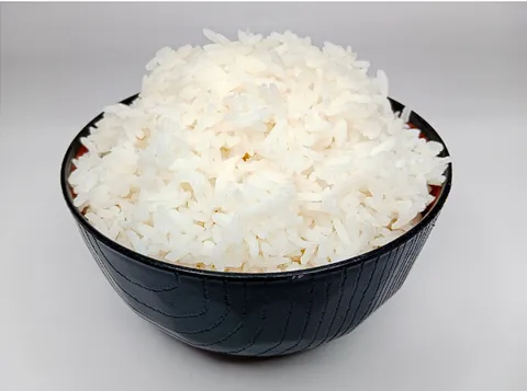 A white bowl filled with plain cooked white rice