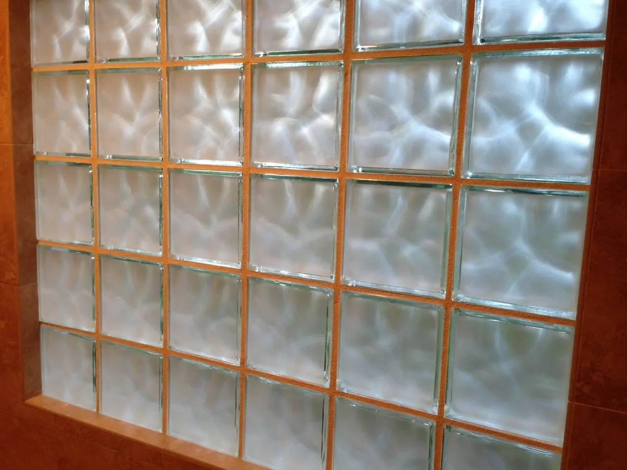 A window pane with a decorative privacy film installed, effectively obscuring the view outside.