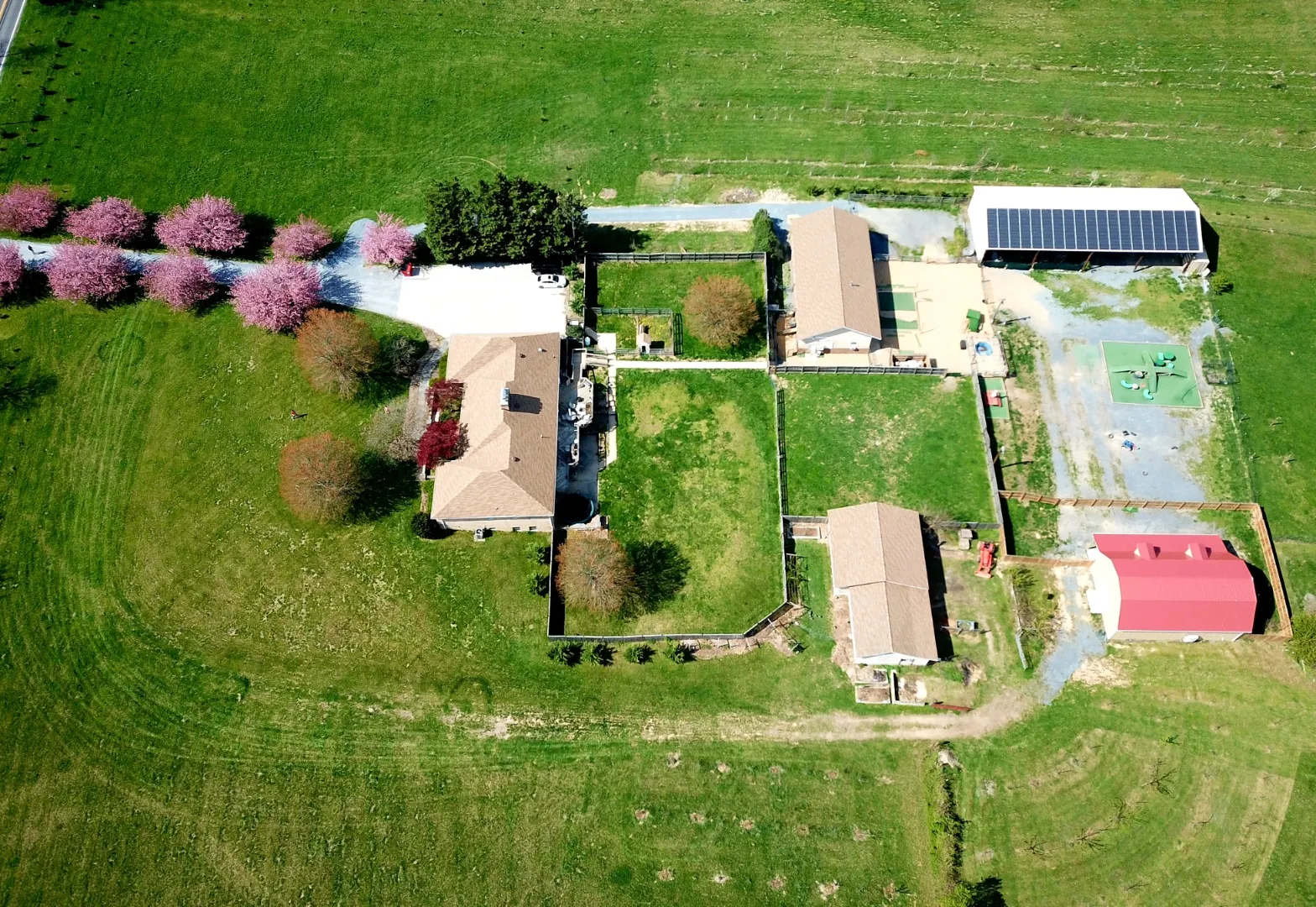 Aerial view of a sustainable farm with solar panels, showcasing eco-friendly operations