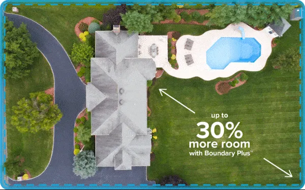 Aerial view of house and yard with outdoor dog fence highlighted around the property with text: up to 30% more room with Boundary Plus