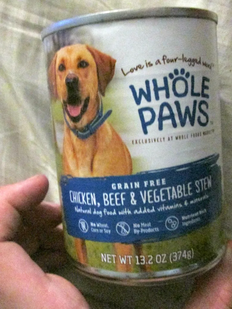 An assortment of Whole Paws canned dog food varieties, showcasing the different flavors available