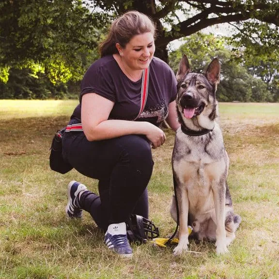 Author Ali Smith from Rebarkable with her dog Indie, demonstrating a positive human-dog bond.